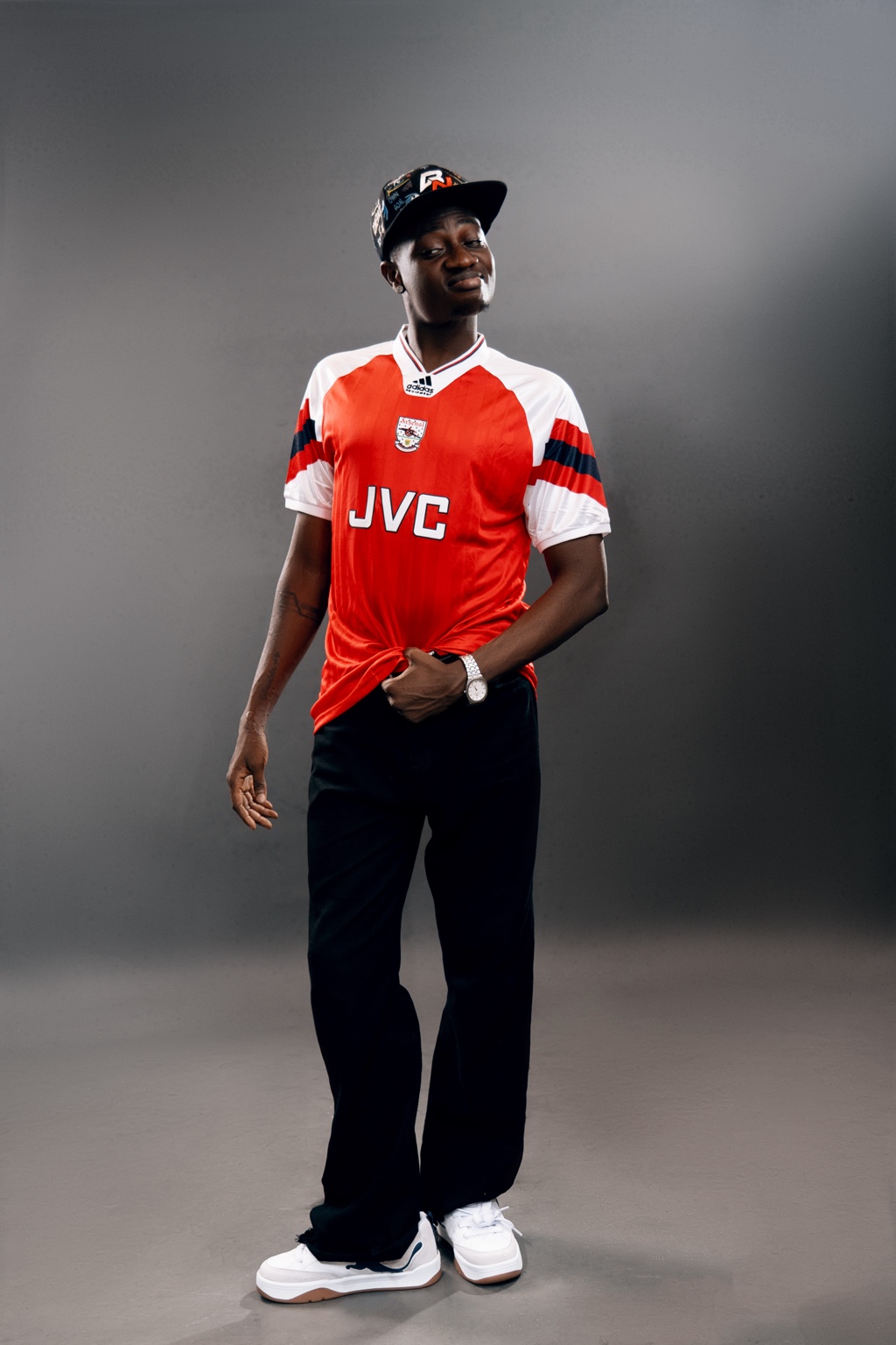 Remote standing in a red football shirt