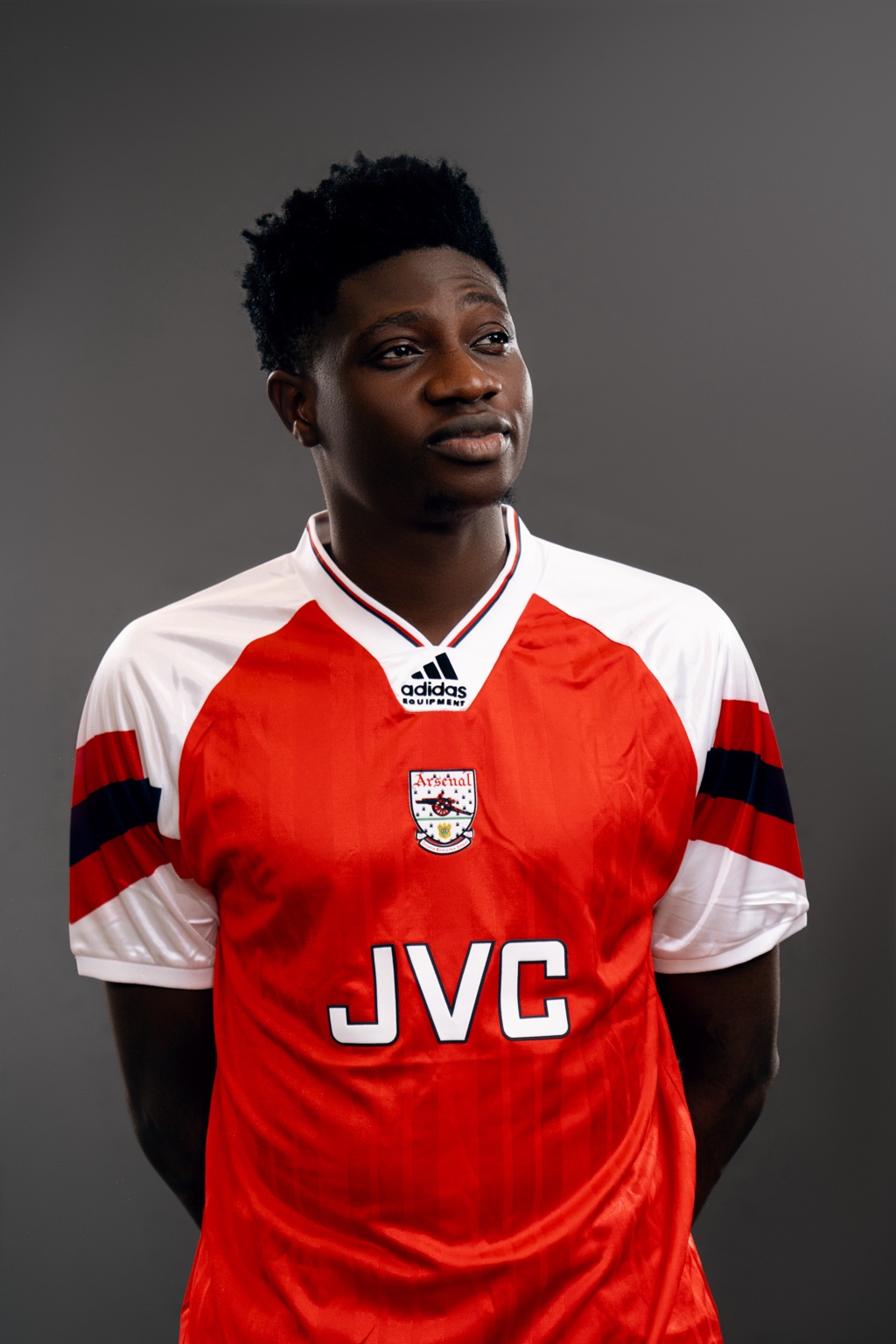 Remote looking off camera in a red jersey